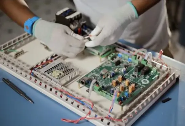 TOBOR engineer working on a charger control board at the Gurugram facility